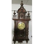 A Victorian eight day chiming wall clock in a stained walnut and beech case with two turned