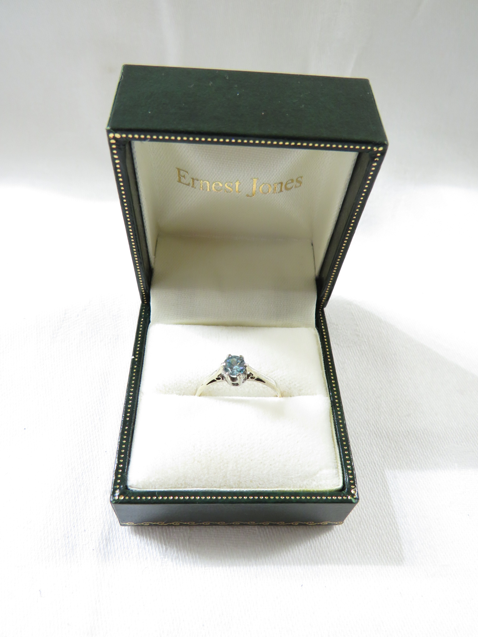 A dress ring set with an aquamarine (diameter 3.5mm), the shank stamped 9ct and toned white - Image 2 of 3