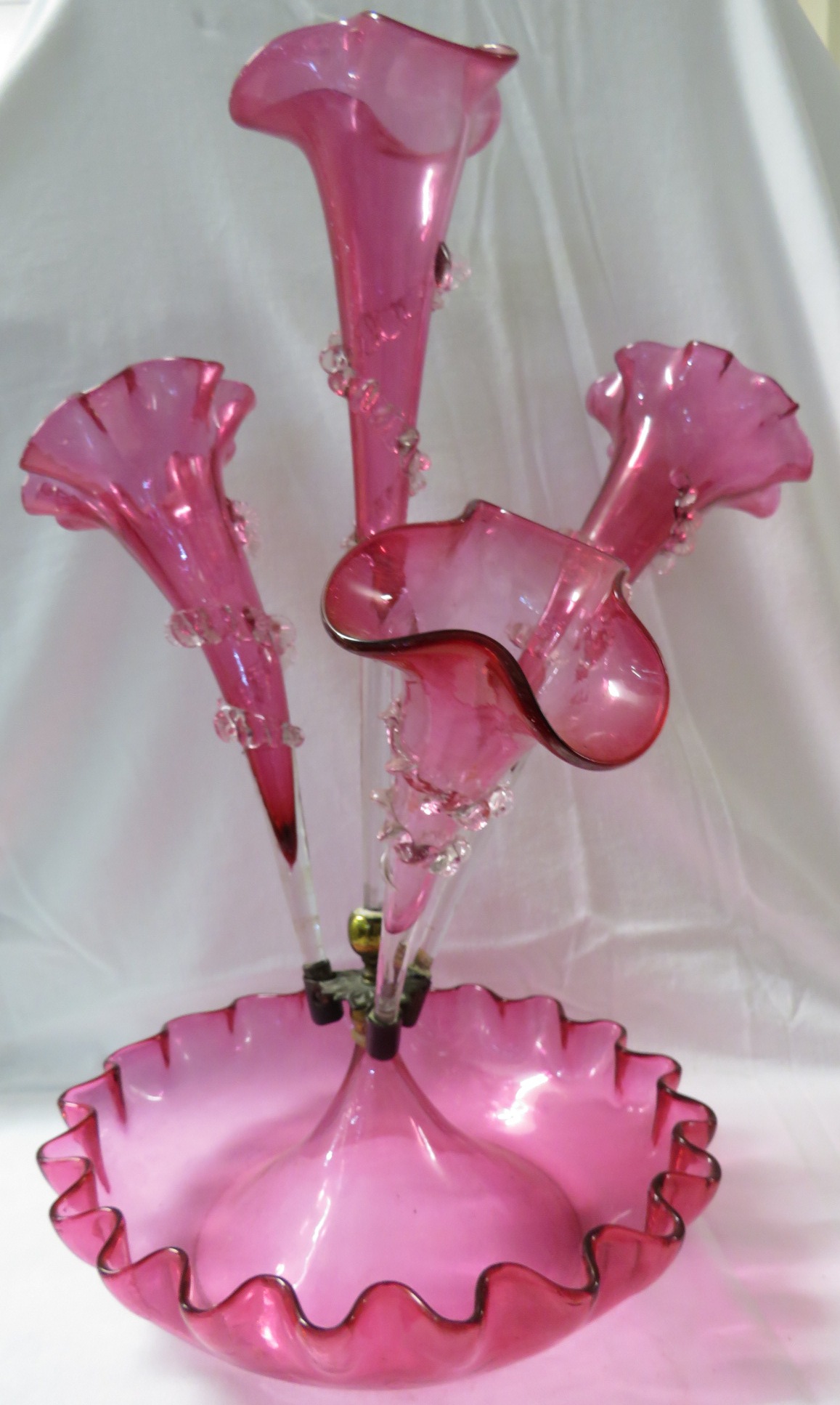 A fine Victorian fluted four stem cranberry glass epergne surmounted on a glass bowl. The trumpet