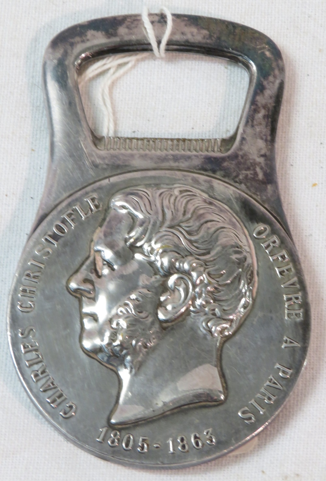 A bottle opener moulded with portrait head and marked CHARLES CHRISTOFLE ORFEVRE A PARIS 1805-