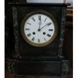 A Victorian eight day striking mantle clock with marble trim, white enamel dial and Roman chapter.