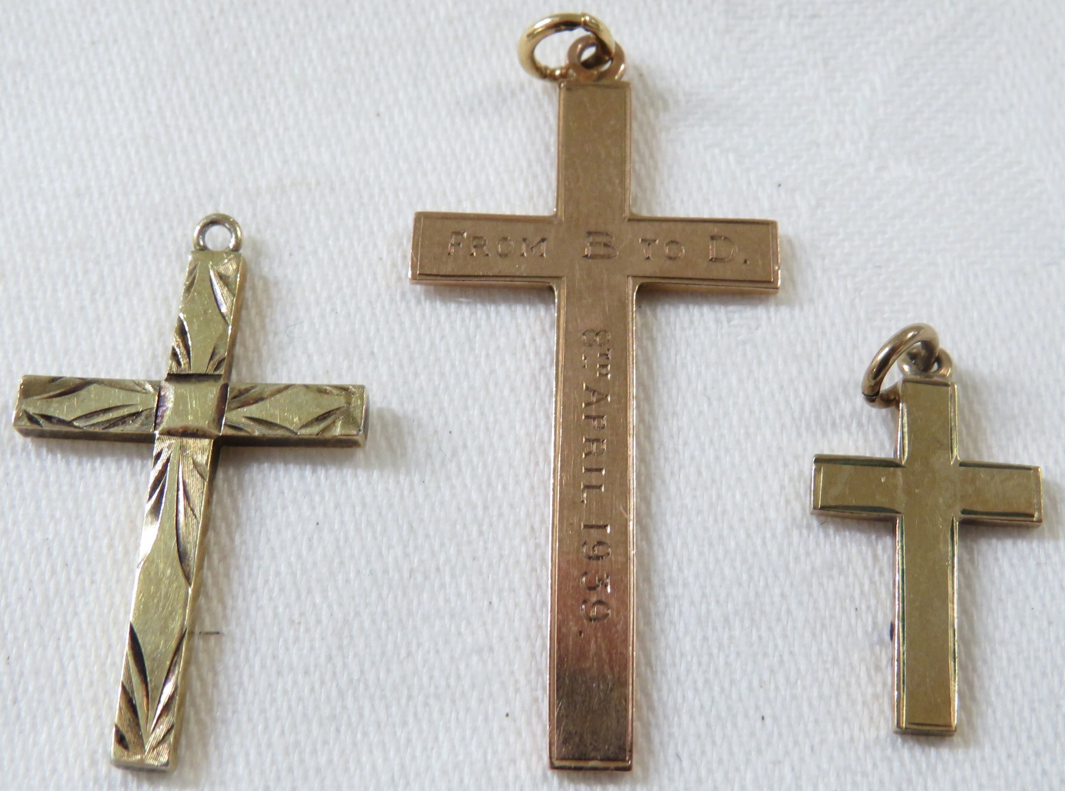 9ct gold cross pendant engraved 1939, (3.3g), a small 9ct gold cross pendant, (1.5g), and a gold