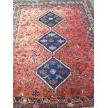 A Persian Baluchi rug with single margin and three medallions with dark red ground, 158cm x 120cm