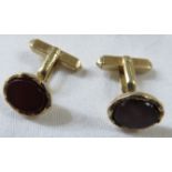 A pair of 9ct gold cufflinks set with un-engraved oval carnelian, combined gross weight 8.7g