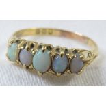18ct gold ring set with a row of five opals (the largest 4mm x 3mm), British hallmarks, 3.3g, size S