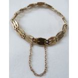 9ct gold bracelet with triple gate links and safety chain, overall length about 18cm, clasp