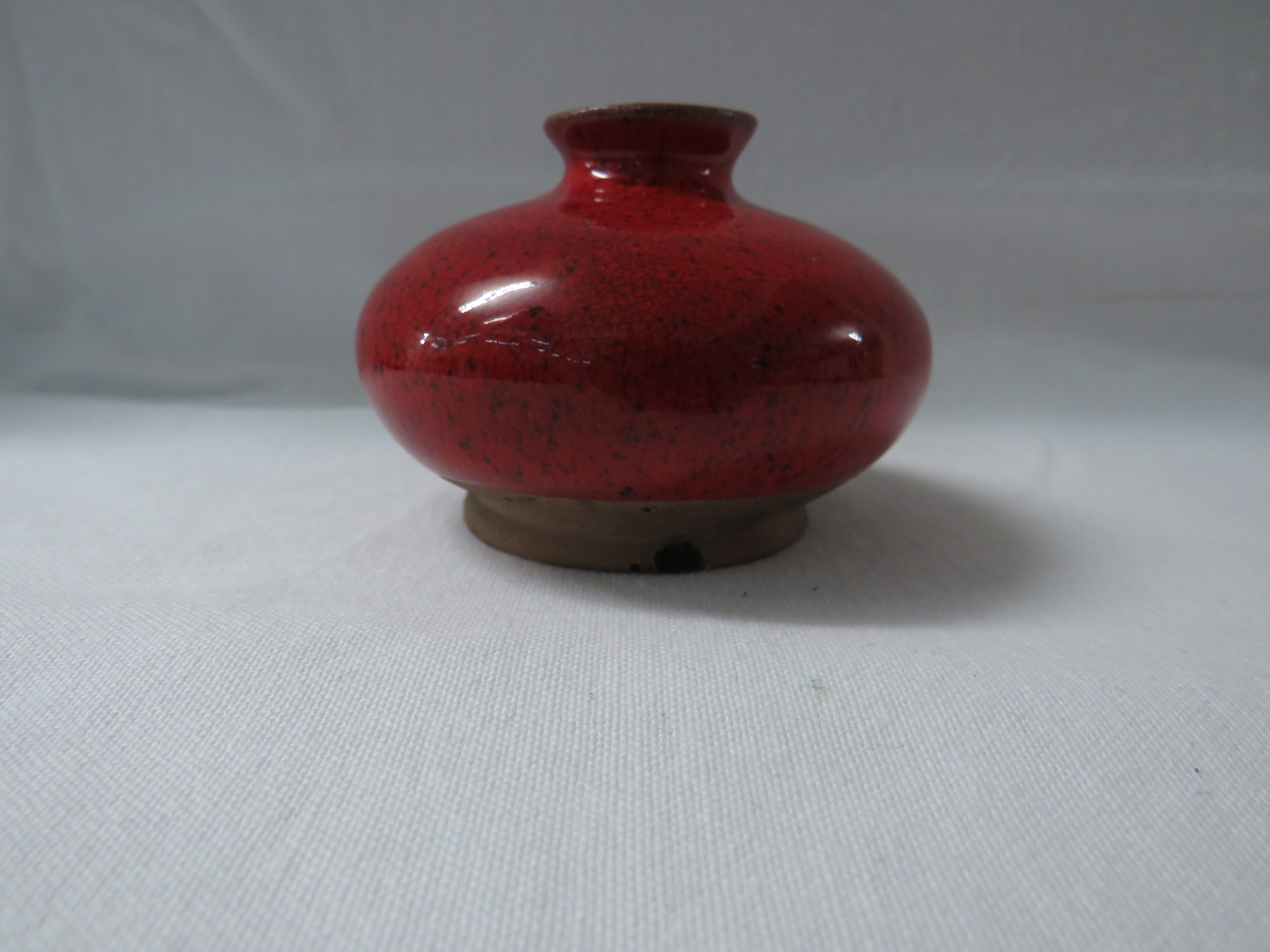 A Ming style terracotta vase or pot of squat form in a bright red mottled glaze falling short of the - Image 3 of 3