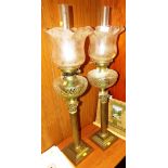 PAIR OF BRASS COLUMN OIL LAMPS WITH CUT GLASS RESERVOIRS AND ETCHED SHADES