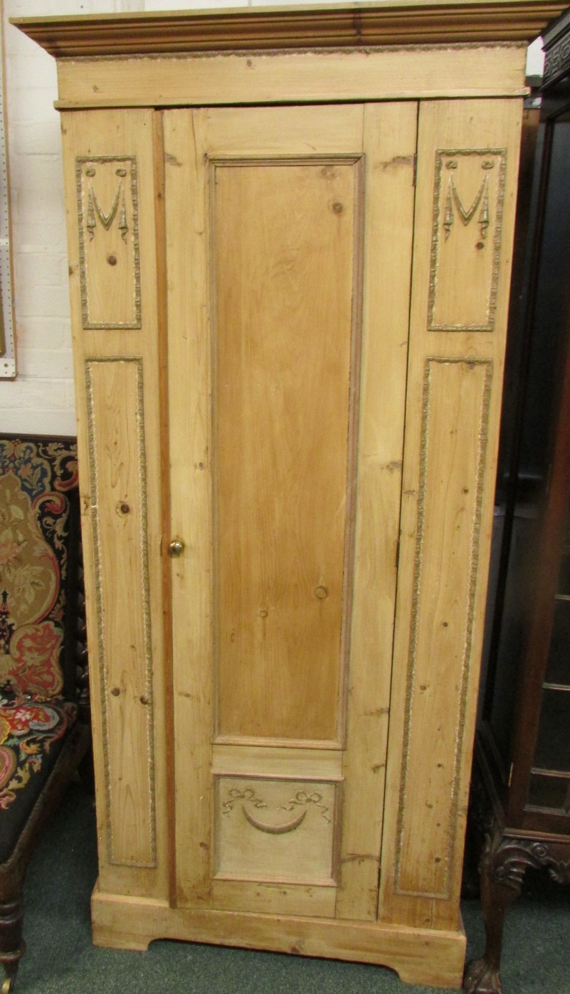 A stripped pine single door wardrobe with applied gesso mouldings height 191cm, width 90cm, depth