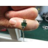 18-CARAT GOLD EMERALD AND DIAMOND RING, EMERALD ABOUT 6.5MM X 4.5MM AND SET CENTRALLY BETWEEN TWO