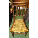 BOBBIN TURNED LOW SIDE CHAIR WITH SHAPED CANE WOVEN SEAT