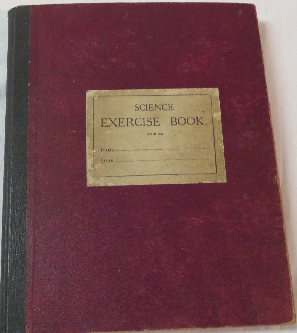 A science exercise book containing used British and foreign stamps including United States,