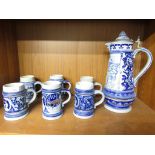 LARGE GERMAN POTTERY BEER STEIN AND SIX MATCHING MUGS