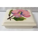 Moorcroft pottery rectangular lidded dish, cream ground, the lid painted with a pink magnolia,