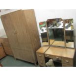 A three part Waring & Gillow limed oak bedroom suite comprising two door wardrobe, dressing table