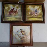 A collection of 3 framed hand painted ceramic tiles with illustrations of game birds