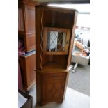 Carved oak corner cupboard with leaded glazed fitted unit.