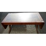 Reproduction antique style coffee table with drop leaf leather top.