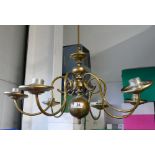 2 brass chandeliers both having 6 arms.