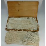 A collection of various vintage lace items in pine wood box