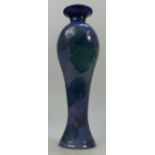 Lise Moorcroft vase with enamelled leaves on blue sprayed ground. 38cm high.