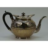 Silver teapot with embossed floral decoration with wooden handle, hall marked London 1801 (637g).