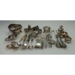 A collection of silver items including serviette rings, cutlery, tea strainers, bowls, hip flask,
