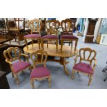 Large pine oval dining table with a set of six matching carved pine dining chairs including two