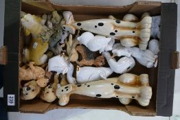A large collection of ceramic and resin figures of dogs and mythical creatures