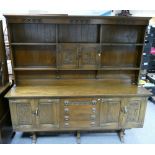 Oak dresser with four door four drawer on rectory style supports, carved detailing,