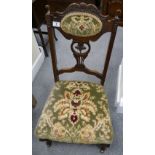 Small carved oak nursery chair, tri-colour flock velour covering, set on brass castors,