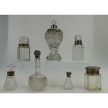 A collection of vintage silver topped crystal glass scent bottles (7)