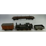 A collection of O Gauge model made railway engines and rolling stock items to include many on brass