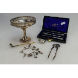 A collection of silver items including sovereign case, footed dish, boxed manicure set,