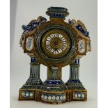 Doulton lambeth stoneware ornate clock,the round dial surmounted by two winged angels,