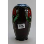Anita Harris floral decorated trial vase on red and blue ground, height 20cm.