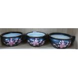 A collection of Carlton Ware peach Blossom items on black ground to include: three matching