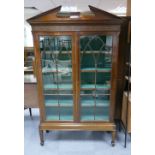 Early 20th Century glass fronted display cabinet with green silk lining.