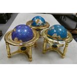 Three Gemstone Globes on metallic gold coloured stand,