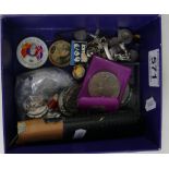 A collection of items including silver charms, silver and other coins, commemorative coins,