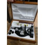 Small wooden cased student microscope with objectives,