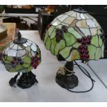 Two reproduction Tiffany style lamps with leaf and berry leaded glass shades.