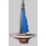 Model of yacht "Optimist" on stand, resin/ metal with wood mast and sail,