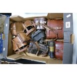 A collection of cased binoculars including opera glasses, WW1 binoculars,