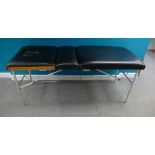 Massage table in black leather