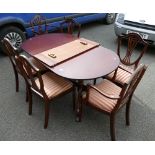 Reproduction mahogany regency style cross banded extending dinning table on ball and claw feet,