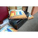 Black cast iron studded travel chest with four pillows with beach front decoration. (5)