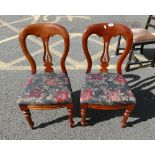 A pair of Victorian style balloon backed chairs with floral upholstered seating. (2)