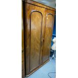 A Victorian Mahogany two door bedroom wardrobe with fitted interior.