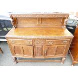 20th carved oak sideboard with with column support back and open legged stretcher base